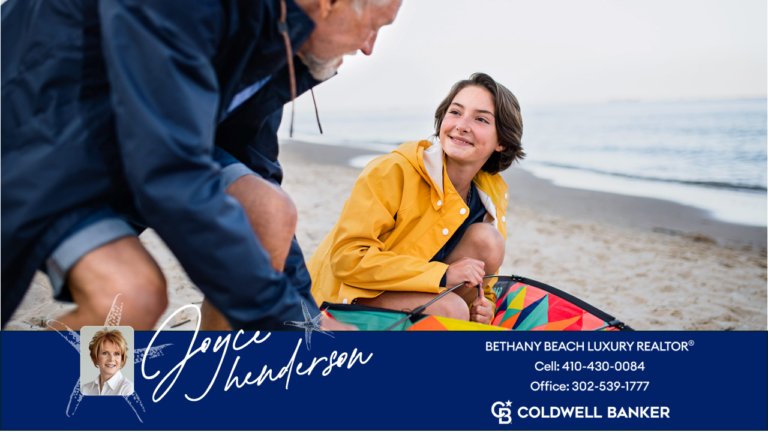 image of father and daughter flying a kite on bethany beach near luxury homes