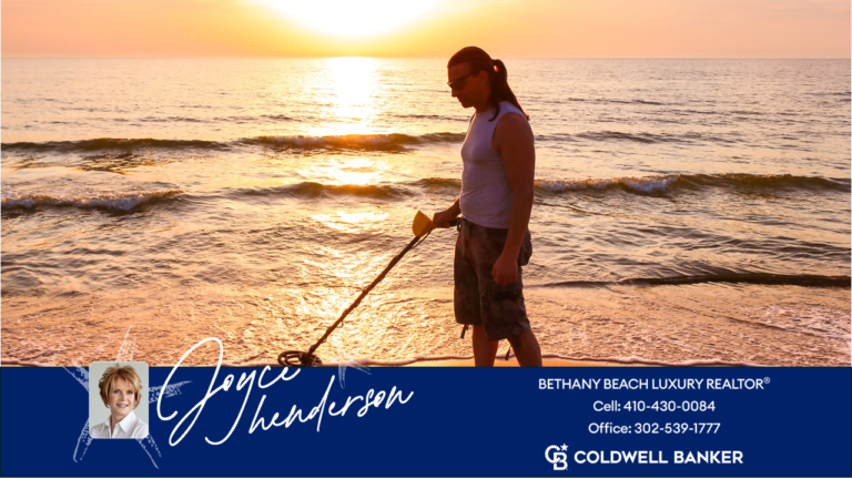 image of a man with a metal detector on the beach in front of bethany beach luxury homes.